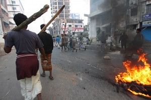 A man sets fire to some substances at Satmatha intersection in Bogra town Sunday morning. Nine people were killed during series of clashes in the district. Photo: STAR 