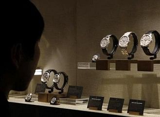A visitor looks at watches on the Vacheron Constantin booth at the ''Salon International de la Haute Horlogerie'' SIHH exhibition at the Palexpo in Geneva January 21, 2013. Photo: Reuters