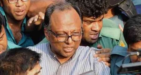 This April 11 photo shows law enforcers taking Mahmudur Rahman, acting editor of Bangla daily Amar Desh, to a court hours into his arrest at the newspaper office in the capital.