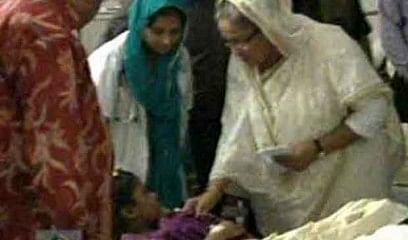 Prime Minister Sheikh Hasina consoles a victim of Savar building collapse at Enam Medical College and Hospital in Savar Monday morning. Photo: TV grab