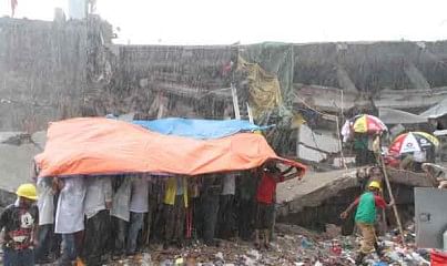 Volunteers show no sign to give in even at the time heavy rainfall on Saturday makes rescue attempts harder at the collapsed building in Savar. Photo: Palash Khan