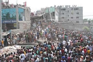 Curious people gather at debris of a nine-storey building that collapsed at Savar Wednesday morning. Star file photo  