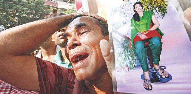 A man in tears with a photo of a missing relative, who worked in Rana Plaza at Savar Bazar bus stand, asks people if they have seen her yesterday. Photo: Rashed Shumon