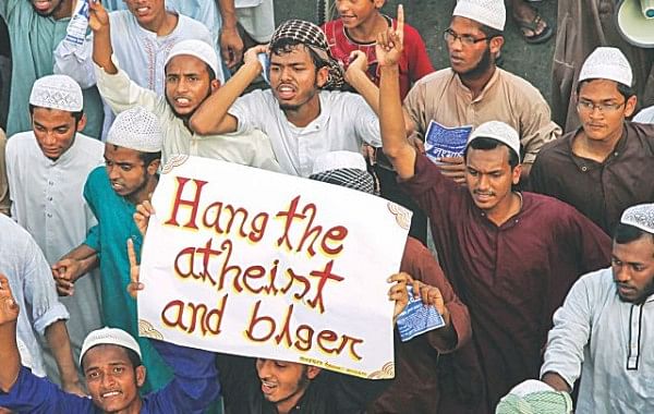 Apparently craving international attention, members of Hefajat-e Islam bring out a procession in the capital's Demra yesterday with an English placard where the word blogger is spelt “blger”. The procession was to drum up support for their Dhaka long march tomorrow demanding punishment of atheists and bloggers. But how much they know about the bloggers or what they do remain a wonder. Photo: Star