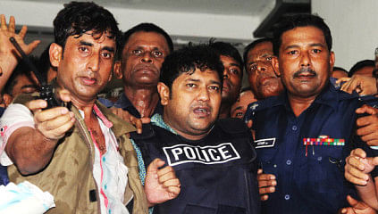 In this April 29 photo, detectives are seen taking Sohel Rana, the owner of Rana Plaza, out of a court in the capital.
