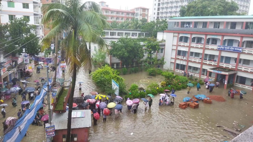 Outside Cumilla Government Women's College in Chartha, several female candidates crossed flooded roads in plastic boats before sitting for their examinations in wet clothes. Photo: Collected