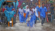 Students wade through submerged streets of the capital. 