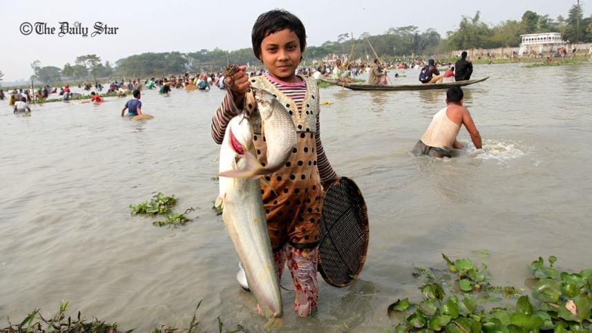 A young girl shows off her catch