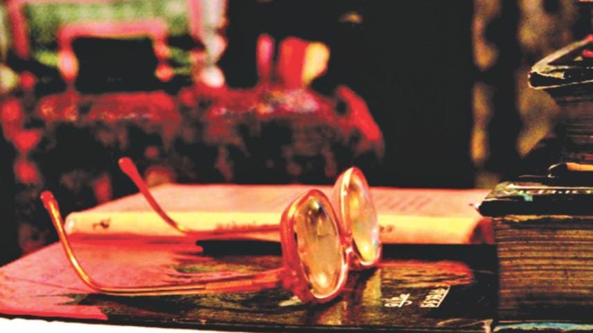 Poet Sufia Kamal's spectales lie forlon on her reading table. 