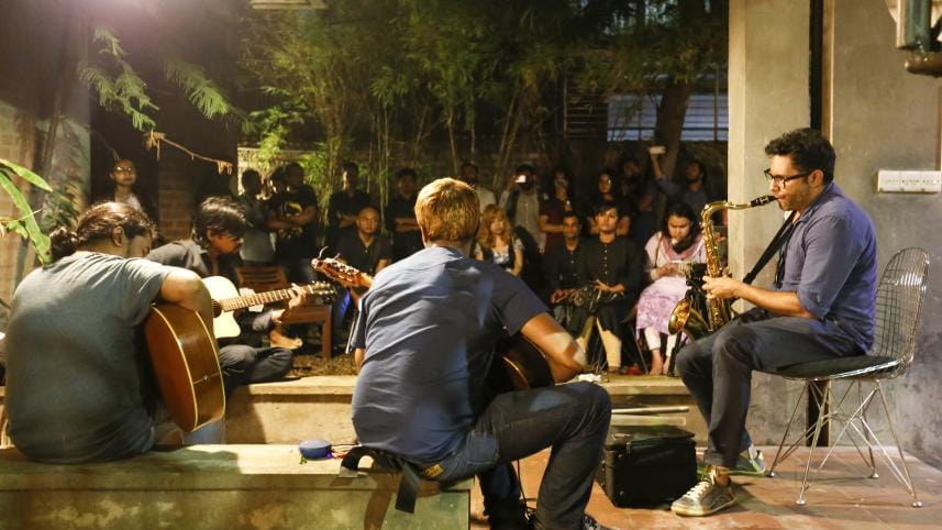 People performing music in an intimate setting. 