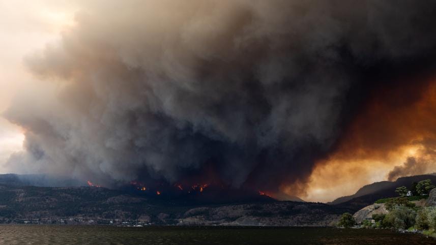 The McDougall Creek wildfire burns in the hills in West Kelowna, British Columbia, Canada, on August 17, 2023, as seen from Kelowna. 
