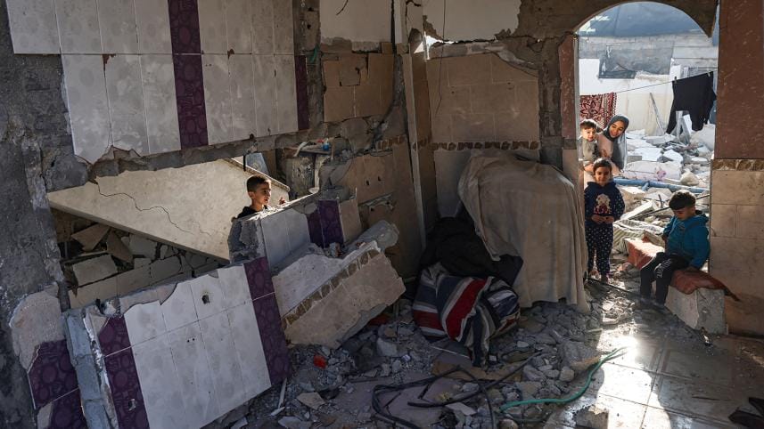 Palestinian youths are seen in the rubble of a damaged house in Rafah in the southern Gaza Strip