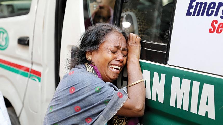 Sheuli Das weeps as she holds onto the ambulance carrying the bodies of her niece Poppy Roy and two grandchildren, after they died in a fire on Bailey Road in the capital on Thursday night. 
