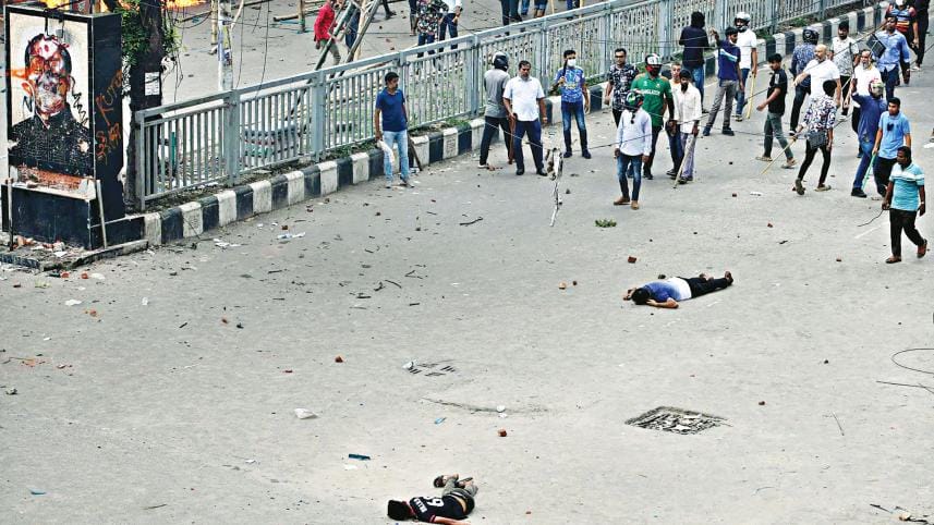 bullet-hit persons lie motionless on the street in Azampur of Uttara in Dhaka