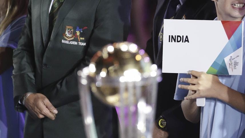 Mashrafe Mortaza and Mahendra Singh Dhoni on stage near World Cup trophy