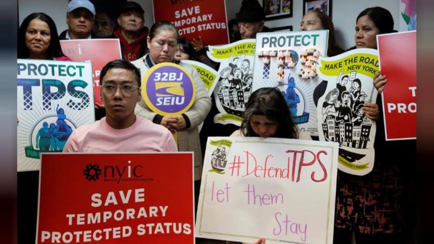 People gather during a news conferenc