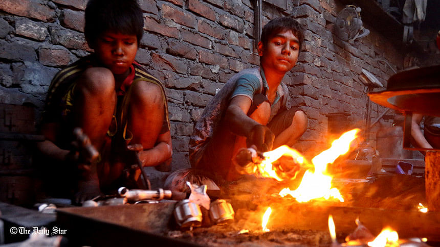 Ten-year old Shohag and his friend work close to open flames Ten-year old Shohag and his friend work close to open flames