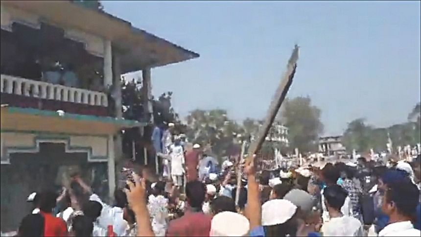 A video grab shows a protester wielding a stick on Sunday A video grab shows a protester wielding a stick on Sunday