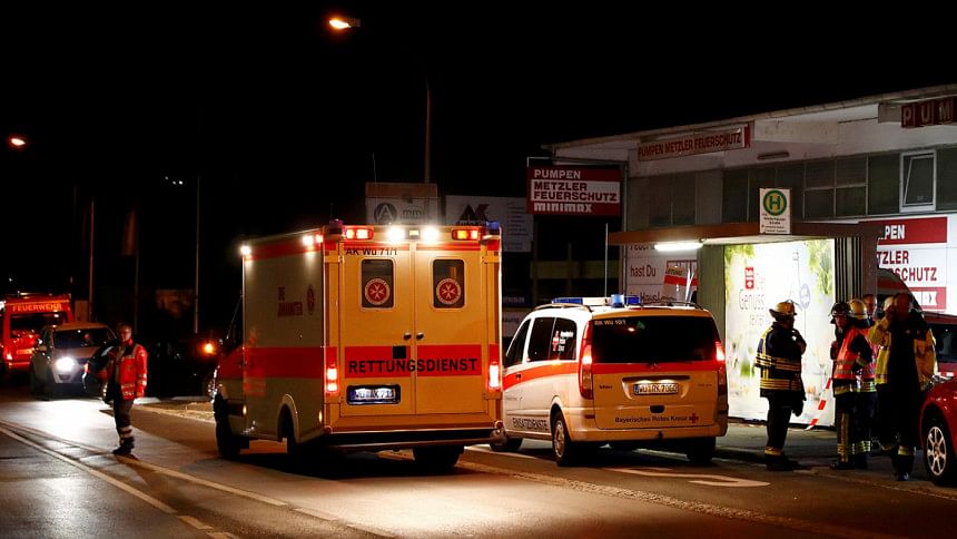 German emergency services workers work in the area where a man with an axe attacked passengers on a train near the city of Wuerzburg, Germany German emergency services workers work in the area where a man with an axe attacked passengers on a train near the city of Wuerzburg, Germany