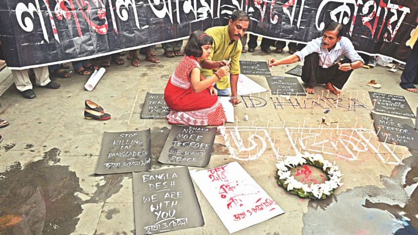 Indian social activists light candles during a protest in Kolkata on Saturday, against a fatal attack on a restaurant in the Bangladeshi capital Dhaka. Indian social activists light candles during a protest in Kolkata on Saturday, against a fatal attack on a restaurant in the Bangladeshi capital Dhaka.