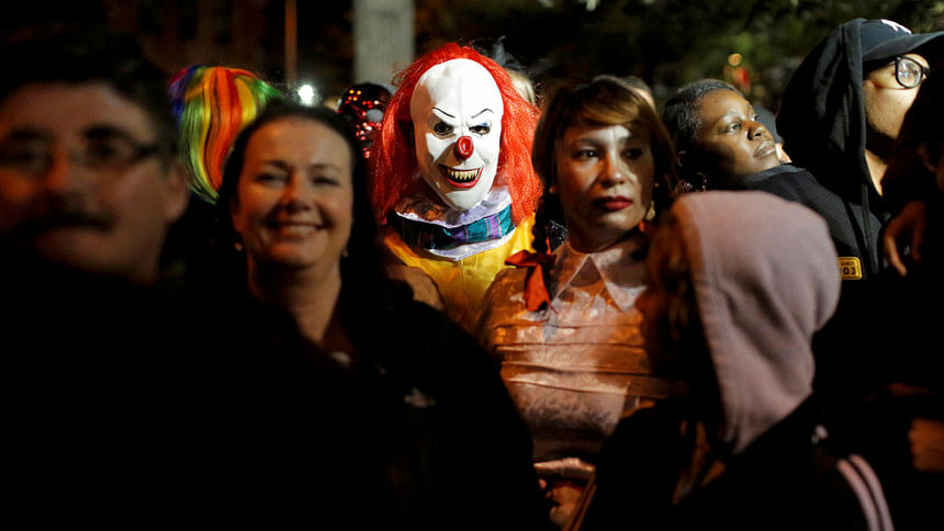 A person dressed in a clown costume A person dressed in a clown costume