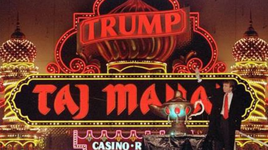 Donald Trump stands next to a genie's lamp as the lights of his Trump Taj Mahal Casino Resort Donald Trump stands next to a genie's lamp as the lights of his Trump Taj Mahal Casino Resort