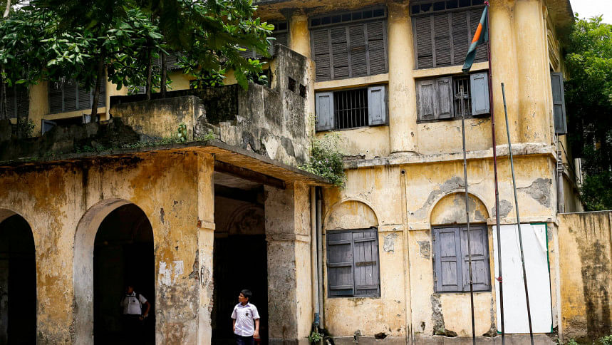 Student in front of old school building