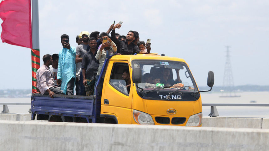 People enjoying the newly inaugurated Padma Bridge on a pickup truck. People enjoying the newly inaugurated Padma Bridge on a pickup truck.