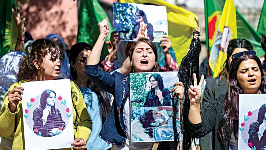 Syrian Kurdish women take part in a demonstration in Syria’s northeastern city of Hasakeh, to express their support for 22-year-old Mahsa Amini (portrait), who died while in the custody of Iranian authorities. Syrian Kurdish women take part in a demonstration in Syria’s northeastern city of Hasakeh, to express their support for 22-year-old Mahsa Amini (portrait), who died while in the custody of Iranian authorities.
