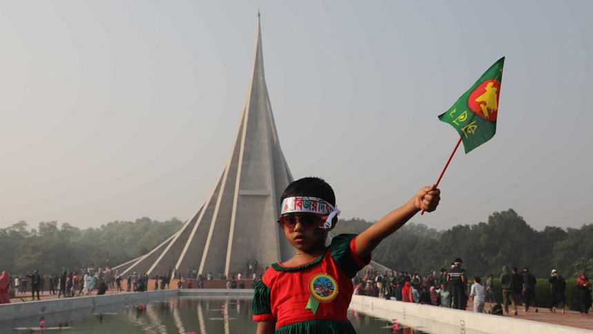 A girl holding a flag in front of National Memorial, Savar. A girl holding a flag in front of National Memorial, Savar.