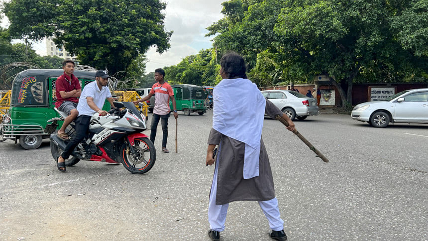 A student in her school uniform seen controlling the traffic in the streets of Dhaka