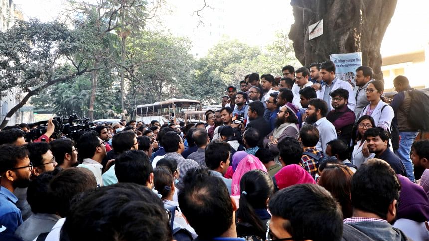 People huddled around group of protestors. People huddled around group of protestors.