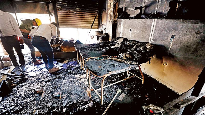 Firefighters inspect the charred debris inside a building in Gulshan’s Shahjadpur area Firefighters inspect the charred debris inside a building in Gulshan’s Shahjadpur area