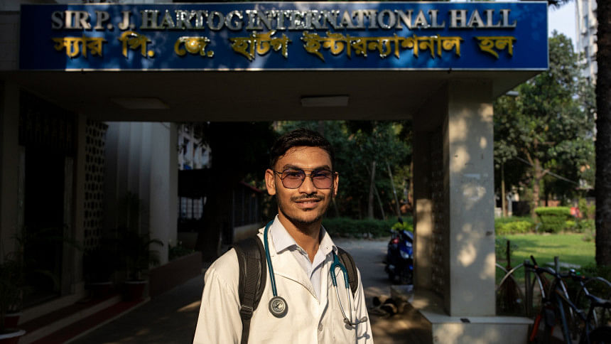An international medical student standing in front of the dorm for international students An international medical student standing in front of the dorm for international students