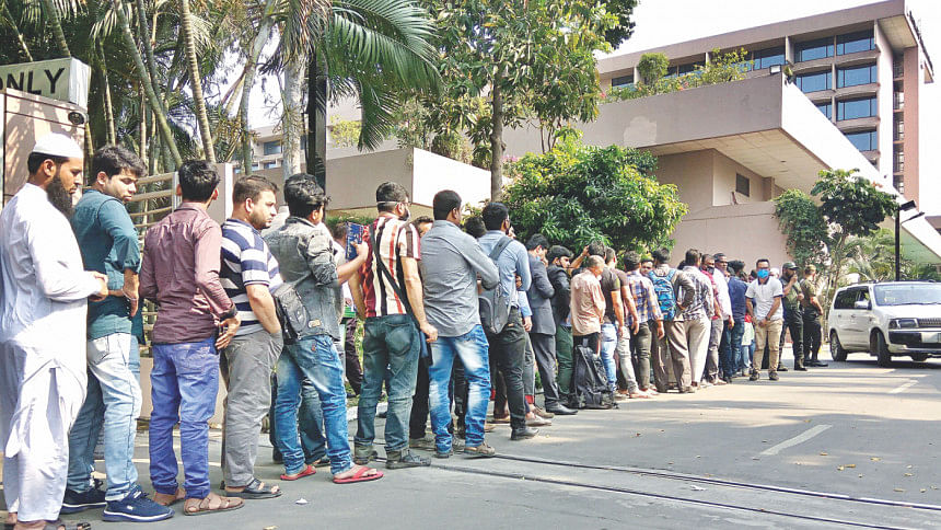Migrant workers waiting in a long queue on the Sonargaon hotel Migrant workers waiting in a long queue on the Sonargaon hotel