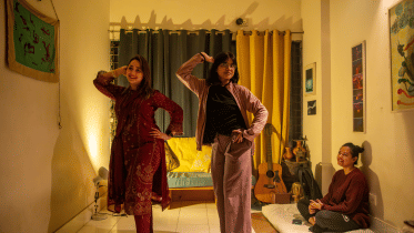 three friends at a holud rehearsal