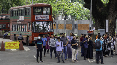 Group of students waiting at the bus stop in the Dhaka University campus.