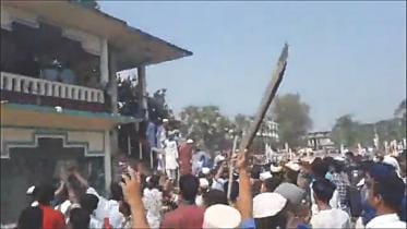 A video grab shows a protester wielding a stick on Sunday