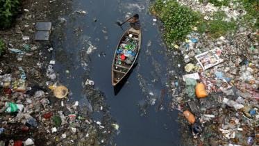 Collecting plastic material from dirty water in Dhaka