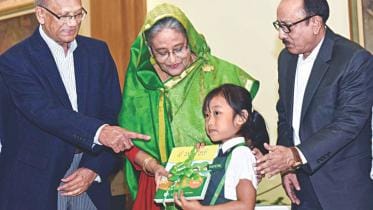 Hasina handing free textbooks.jpg
