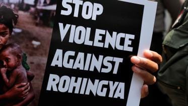 A protester holds a placard during protest against Myanmar's treatment