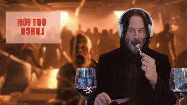 Keanu Reeves enjoying a meal while a swarm of zombies is trying to break in. 