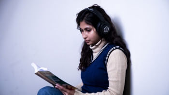 Girl listening to music while studying