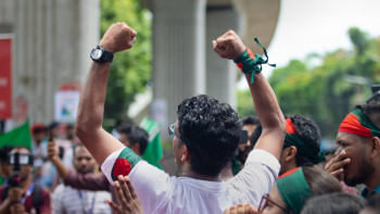 Student chanting with both their fists raised.