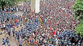 Students break through a police barricade in the capital’s Shahbagh around 5:30pm yesterday during a demonstration demanding reforms of the quota system in government jobs. Students from different public universities and colleges have been staging protest
