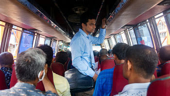 A student standing inside a bus.   A student standing inside a bus.