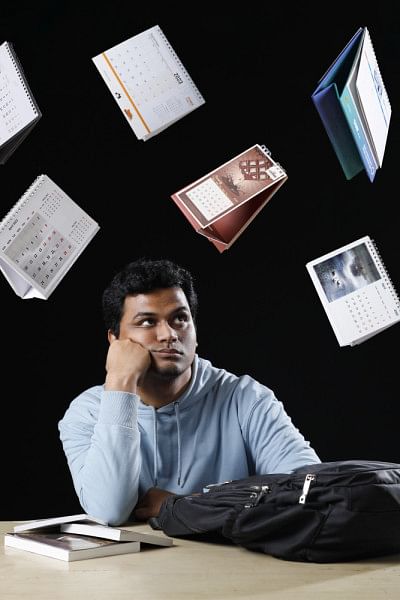 A university student concerned which is symbolised through calendars rushing down on him.