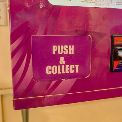 Push and collect feature for a sanitary pad vending machine