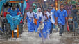 Students wade through submerged streets of the capital. 