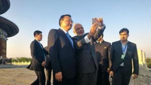 Prime Minister Narendra Modi and Chinese Premier Li pose for a selfie at the Temple of Heaven in Beijing.